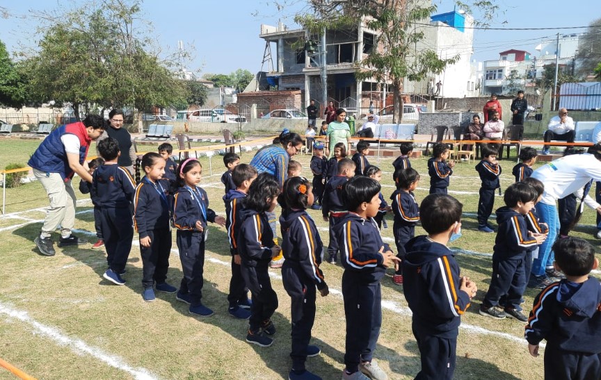 Several students of the school performing freeze dance in the park.