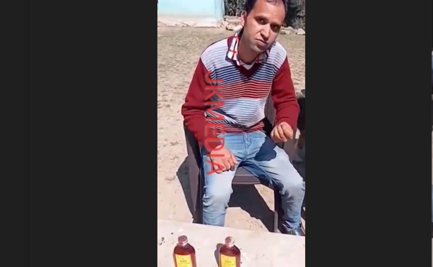 Teacher and liquor bottles which locals recovered from him.