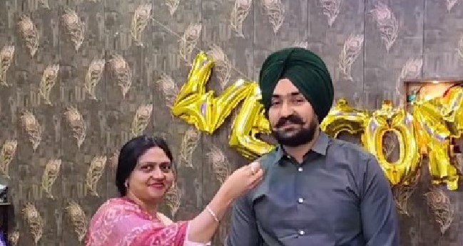 Namneet Singh of RS Pura being fed sweets by his mother after cracking IAS