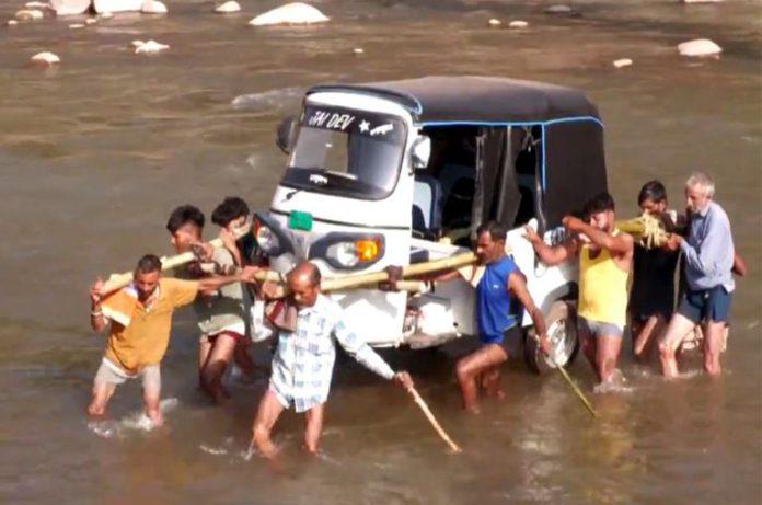 Locals Carry Auto Rickshaw On Shoulders After Key Bridge Washed Away In Udhampur Locals Carry Auto Rickshaw On Shoulders After Key Bridge Washed Away In Udhampur’s Village