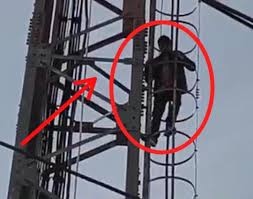 images - 2025-12-18T114359.617 Man Climbs Telecom Tower in Jagti Camp Protest Over Shop Allotment